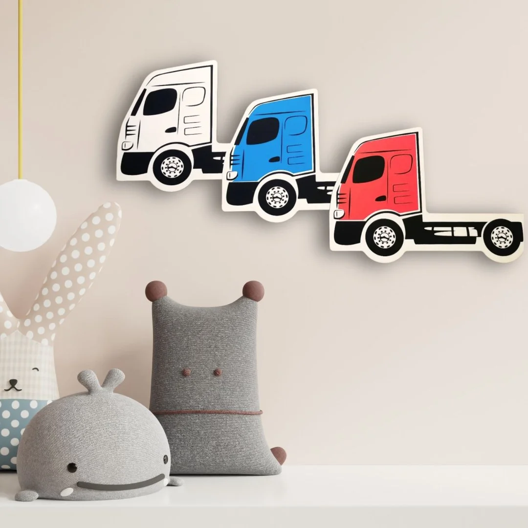 Naklejki z ciężarówkami w kolorach białym, niebieskim i czerwonym na ścianie.