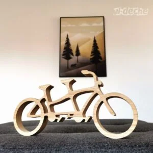 Drewniany rower tandem na tle obrazu z górami.