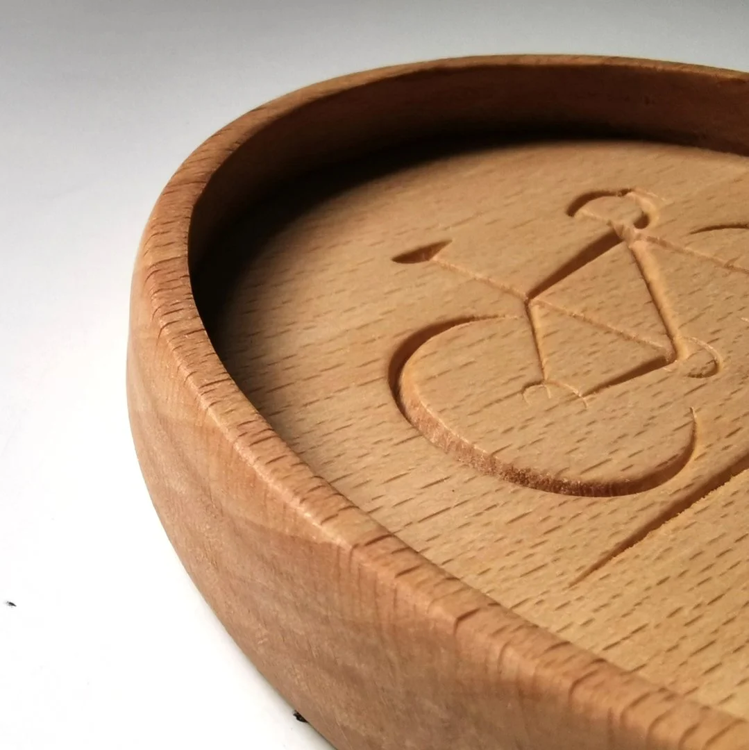 Drewniana podstawka z rowerowym motywem.